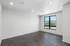 Bright and spacious room with large window, offering a serene view and modern flooring.
