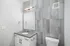 Modern bathroom with sleek tile design, stylish vanity, and contemporary fixtures.