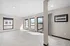 Bright and airy living space with large windows, sleek tiled floors, and modern air conditioning unit.