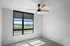 Bright and airy bedroom with large window, modern ceiling fan, and elegant neutral decor.