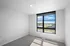 Bright and spacious room with a wide window offering a scenic city view, perfect for a modern lifestyle.