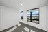 Bright and airy apartment corner with large windows offering stunning city views, perfect for a cozy reading nook or office space.