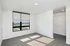 Bright and welcoming bedroom with large window, neutral walls, plush carpeting, and spacious walk-in closet.