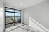 Bright and modern room with large floor-to-ceiling window offering expansive city views.