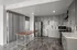 Modern kitchen with sleek grey cabinets, stainless steel appliances, and a spacious wooden island, featuring stylish tile backsplash and contemporary flooring.
