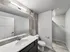 Modern bathroom featuring a sleek vanity, large mirror, and elegant tile accents.