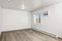 Bright, spacious room with sleek hardwood flooring and modern air conditioning unit, perfect for a cozy living space.