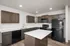 Modern kitchen with sleek dark cabinetry, spacious counters, and an island centerpiece, ideal for entertaining.