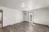 Bright, modern room with sleek wooden flooring, a door leading to an outdoor space, and ample natural light.