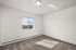 Bright, airy room with large window showcasing stunning countryside views, perfect for a cozy bedroom or home office.