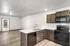 Modern kitchen with sleek cabinetry, stainless steel sink, and spacious open-plan design leading to a bright living area.
