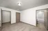 Spacious bedroom featuring plush carpet, large walk-in closet, and direct access to a modern bathroom with sleek fixtures.