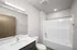 Modern bathroom with sleek fixtures, a spacious bathtub, and elegant lighting, offering a serene and stylish retreat.