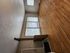 Bright and inviting living room with large windows and beautiful hardwood floors, perfect for comfortable living.