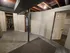 Versatile basement space with potential for customization, featuring exposed beams and multiple entryways.