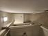 Cozy corridor bathroom with modern lighting, sleek tiling, and compact layout.