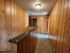 Charming hallway with warm wooden paneling and vintage rustic decor, creating a cozy cabin-like atmosphere.