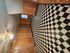 Charming room with retro checkered flooring, elegant wood paneling, and cozy ambiance ideal for creative living space.