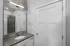Sleek modern bathroom with minimalist design, featuring a spacious countertop, stylish mirror, and elegant fixtures.