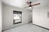 Bright and airy room featuring a modern ceiling fan, large window with a view, and sleek tiled flooring.