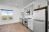 Bright and modern kitchen with sleek appliances, ample cabinetry, and a scenic window view.