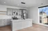 Bright, modern kitchen with sleek cabinetry, stainless steel appliances, and large window offering stunning views.