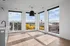 Bright, open apartment space with large modern windows offering a stunning city view and abundant natural light.