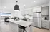 Modern open-concept kitchen with sleek cabinetry, stainless steel appliances, and inviting living area with a scenic view.