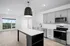 Sleek modern kitchen with stainless steel appliances, elegant cabinetry, and large window offering scenic views.