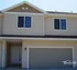 Charming townhouse exterior with inviting front entrance and modern garage by Oxford Realty.