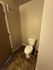 Modern bathroom featuring sleek tile flooring and a compact design, perfect for maximizing space.