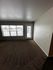 Bright and inviting living room with large windows offering scenic views and access to a private patio.