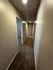 Inviting hallway with soft carpeting and neutral tones, leading to multiple rooms, offering a warm and spacious feel.