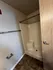 Elegant bathroom with modern shower, tile flooring, and sleek wooden door.