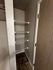 Contemporary closet with sleek wire shelving and modern tile flooring, maximizing efficient storage space.