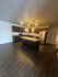 Modern kitchen with sleek dark wood cabinetry, granite countertops, stainless steel appliances, and an inviting island, perfect for culinary enthusiasts.