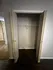 Spacious closet with double doors and sleek wood flooring, ready to meet all your storage needs.