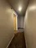 Inviting hallway with modern lighting and plush carpeting leading to interior doors.