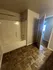 Modern bathroom with elegant tile flooring and a sleek shower-tub combination.