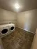 Spacious laundry room with modern washer and dryer units on stylish tiled flooring.