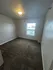 Bright and inviting bedroom with plush carpeting and a large window offering ample natural light.