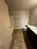 Modern bathroom with elegant tile flooring, sleek granite countertop, and spacious bathtub.