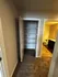Inviting hallway with plush carpet leading to a modern bathroom and spacious built-in closet.