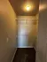 Bright and spacious walk-in closet with ample shelving and elegant lighting, offering storage solutions and style.