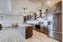 Modern open-concept kitchen with sleek cabinetry, stainless steel appliances, and a spacious island with pendant lighting.