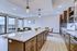 Modern open-concept apartment featuring a sleek kitchen with island, spacious living area, and scenic balcony views.