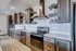 Modern kitchen with sleek stainless steel appliances, elegant wooden cabinetry, and stylish open shelving.