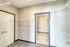 Spacious walk-in closet with ample shelving and modern gray design.