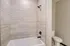 Elegant bathroom with modern tile design and luxurious bathtub.