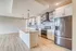 Spacious modern kitchen with sleek stainless steel appliances, white cabinetry, and a large central island, perfect for entertaining.